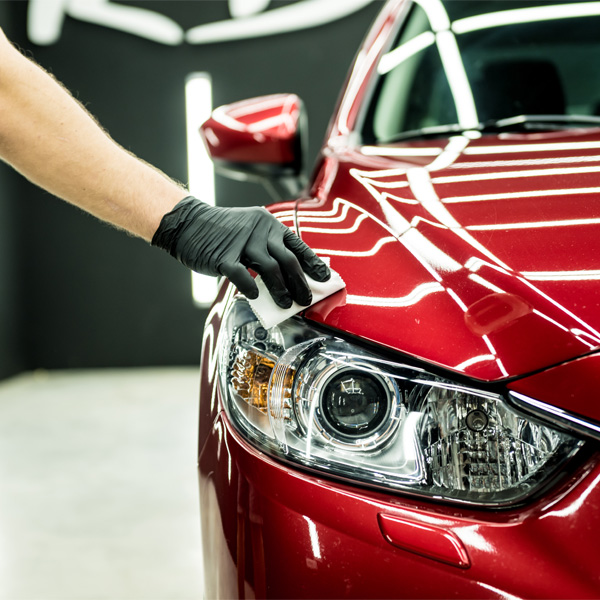 worker applying nano coating on a car detail